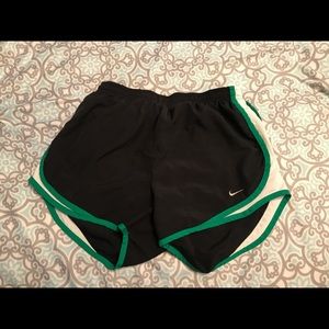 Small black Nike shorts with green and white sides